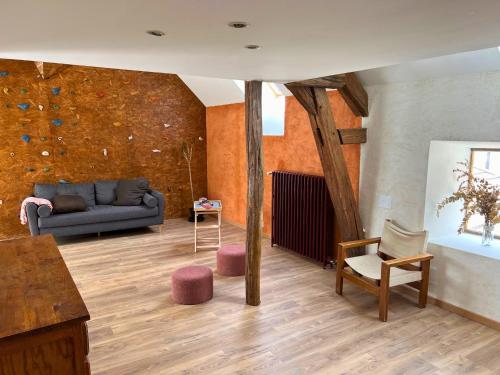 a living room with a couch and a chair at Charmant gîte au cœur des vignes - Rive de Champagne in Vandières-sous-Chatillon