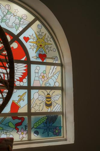 a stained glass window with a bee on it at Casa Faena Miami Beach in Miami Beach