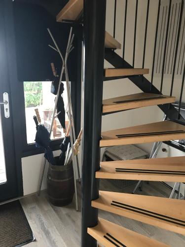 a set of wooden stairs in a room with a plant at Studio Vúr de Diek in Spakenburg