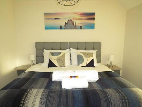 a bedroom with a large bed with towels on it at Impeccable Home with Parking in Bristol