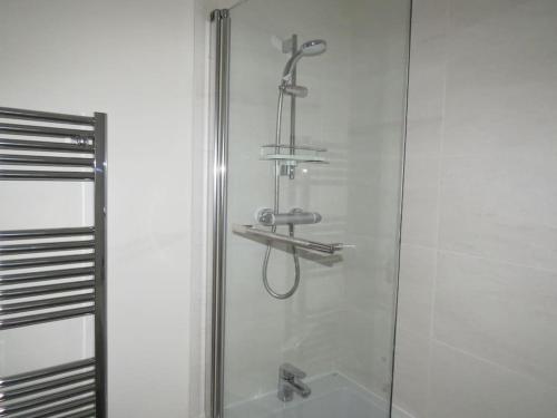 a shower in a bathroom with a glass door at Impeccable Home with Parking in Bristol