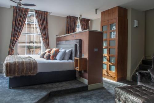 a hotel room with a bed and a large window at Lace Market Hotel in Nottingham