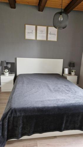 a bedroom with a bed and three pictures on the wall at Ferienwohnung Balzereit in Averlak