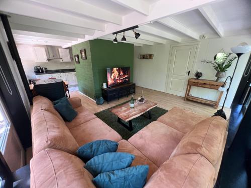 a living room with a couch and a fireplace at Vakantiehuis Lanaken in Lanaken