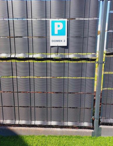 a large metal building with a sign on it at Luxury Apartments Bernardyńska Domek 1 , 2 in Kielce