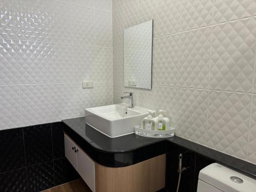 a bathroom with a sink and a mirror at Sun Ray Private Pool villa 3 bed in Ao Nang 
