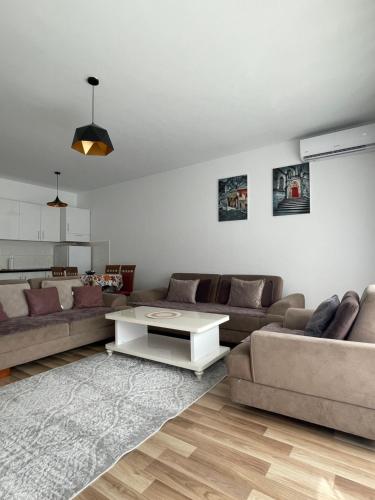 a living room with a couch and a table at Entire Apartment - near the Center in Pristina