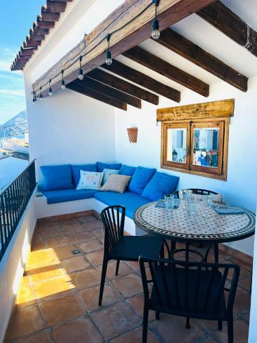 a living room with a blue couch and a table at Casa Pepita in Altea