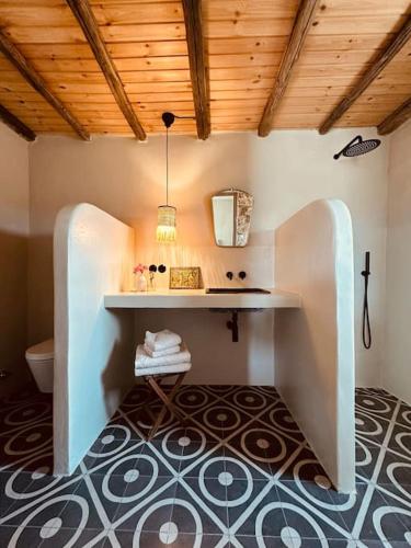a bathroom with a table and a toilet in a room at Μονοπάτι in Agia Anna Naxos