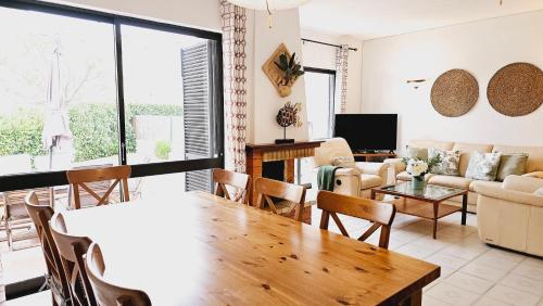 a living room with a table and a couch at Villa charmosa V3 junto à praia e à Marina de Vilamoura in Quarteira