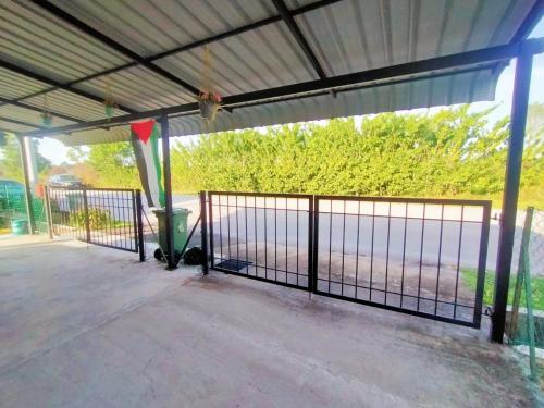 a metal gate on a patio with a fence at Khadijah Islamic Homestay Kuantan in Kuantan
