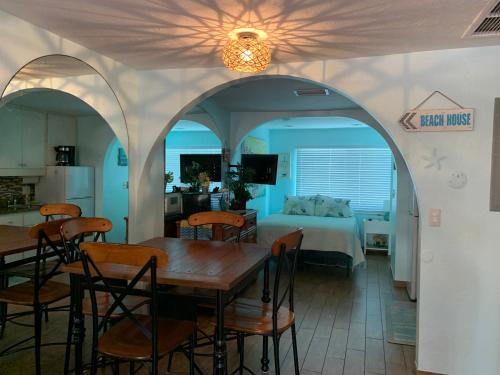 a kitchen and a bedroom with a table and a bed at Coquina Beach Club 109 in Anna Maria