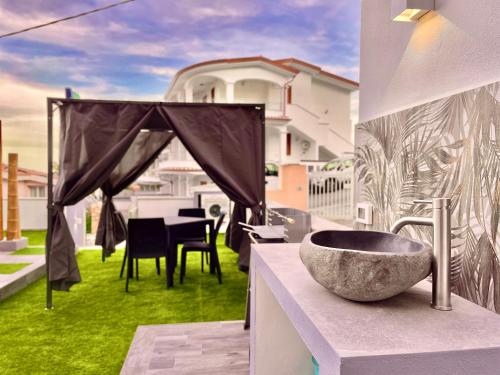 a bathroom with a bowl sink on a balcony at Bellavista luxury apartments in La Caletta