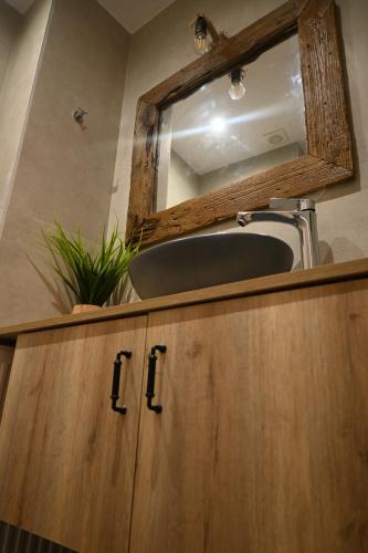 a bathroom with a sink and a mirror at Anezina Cretan hospitality in Heraklion