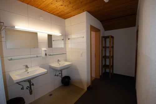 a bathroom with two sinks and a mirror at Tanzalm Jerzens in Jerzens