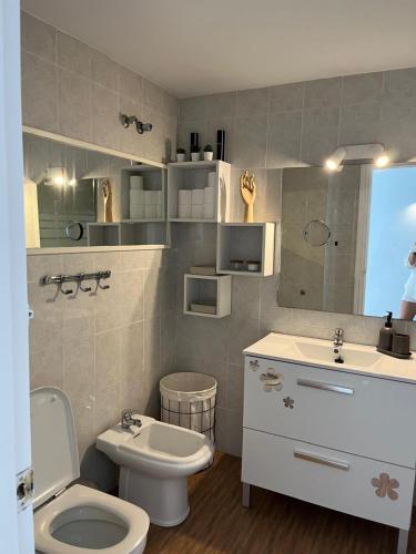 a bathroom with a white toilet and a sink at Kandy Apartment in Mijas Costa