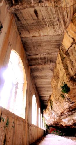 an empty tunnel with a stone wall and windows at Casa Cueva Las Chicas del Puente in Setenil