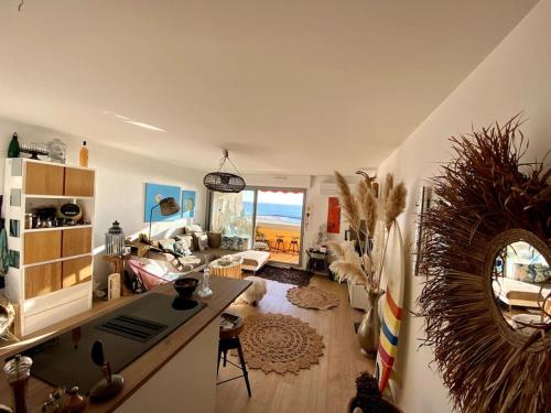 un salon avec une table et un canapé dans l'établissement VU MER et ETANG appartement traversant, à Palavas-les-Flots