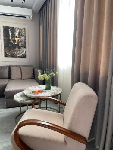 a living room with a couch and a table at Scandi Apartaments in Durrës