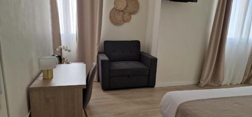 a bedroom with a chair and a bed and a table at Ura Hotel Boutique Gurea in Las Palmas de Gran Canaria