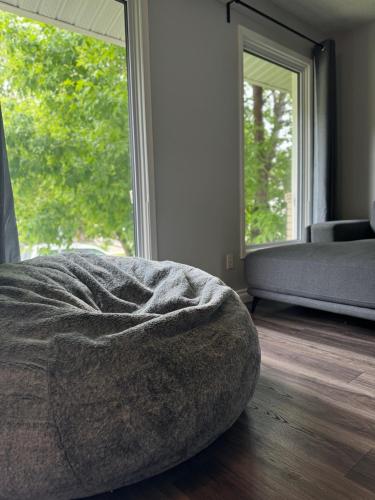 a bedroom with a bed and a large window at Modern home in Downtown Wpg in Winnipeg