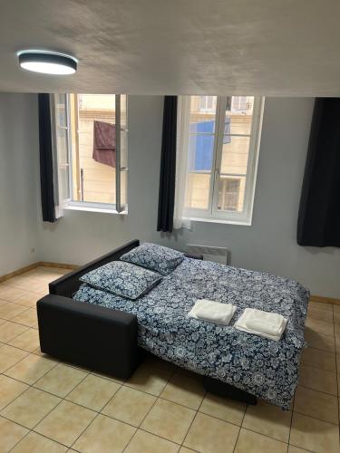 a bedroom with a bed with two towels on it at Thubaneau St Charles Canebière Vieux port in Marseille