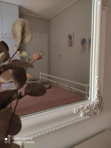 a mirror with a reflection of a person in a room at Astros Family Apartment in Paralion astros