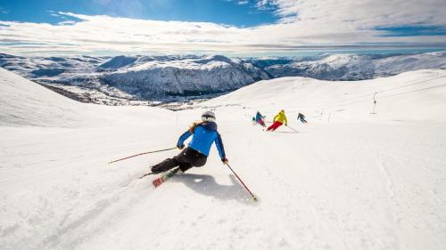 a group of people skiing down a snow covered slope at Kinsarvik Fjordhotel, BW Signature Collection in Kinsarvik