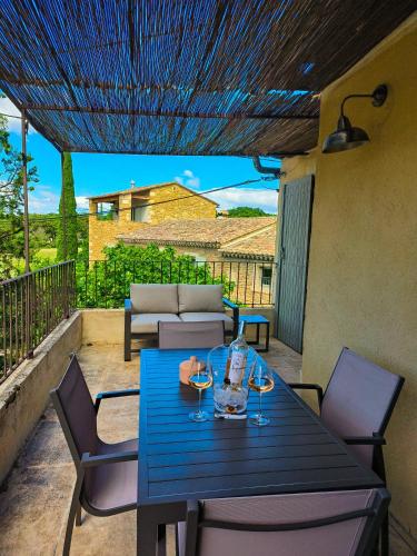 a blue table and chairs on a patio at Domaine de Montine Chambres de Charme in Grignan
