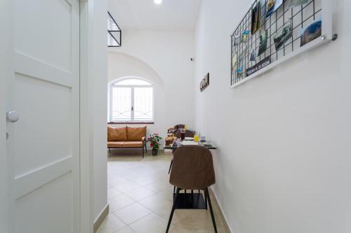 a hallway with a chair and a table in a room at Vesuvio Plaza Room in Ottaviano