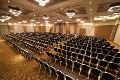 an empty lecture hall with rows of chairs at Novotel Konya in Konya
