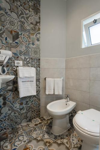 a bathroom with a toilet and a sink at Vesuvio Plaza Room in Ottaviano