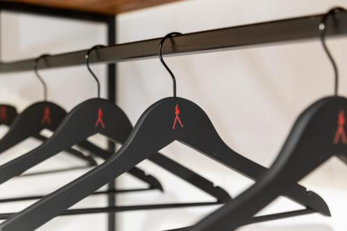 a row of clothes racks with red crosses on them at Vesuvio Plaza Room in Ottaviano