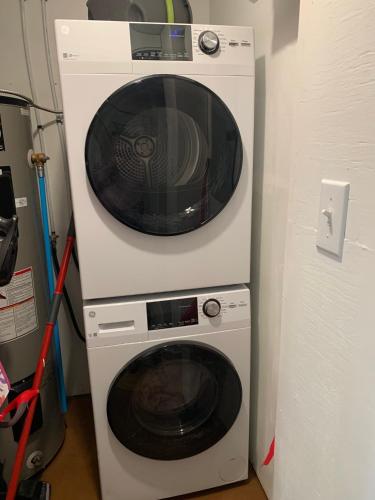 a microwave and a washing machine in a room at Two bedrooms and large office close to Halifax Citadel in Halifax