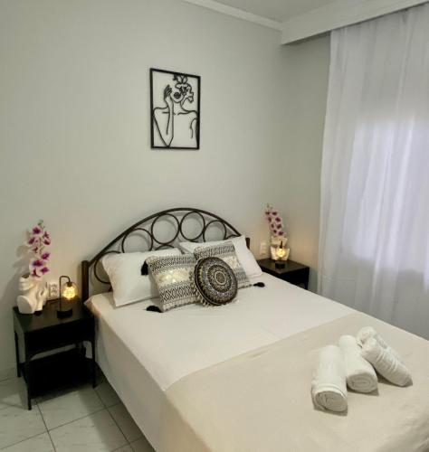 a bedroom with a bed with two towels on it at PerAmore Apartment in Nea Peramos