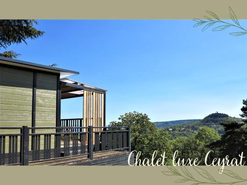 a house with a large deck with a view at Hotel De Plein Air Le Chanset in Ceyrat