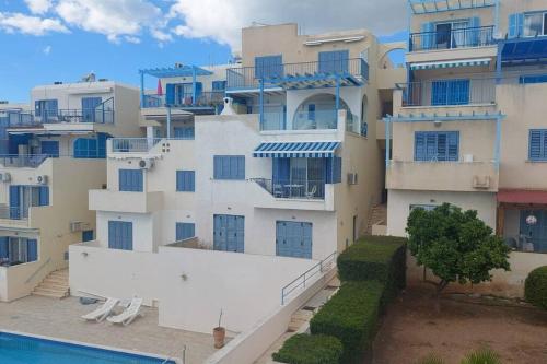 a large apartment building with a pool in front of it at Pelagos Panorama 2B, Seaview, Pool in Chlorakas
