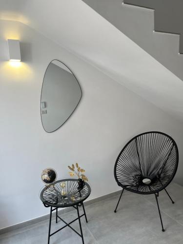 a room with a mirror and a chair and a table at Room 28 in Conversano