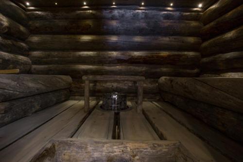 a room with a table in a wooden room at Kelo Villa for 8, with hot tub, by lake Päijänne in Jyväskylä