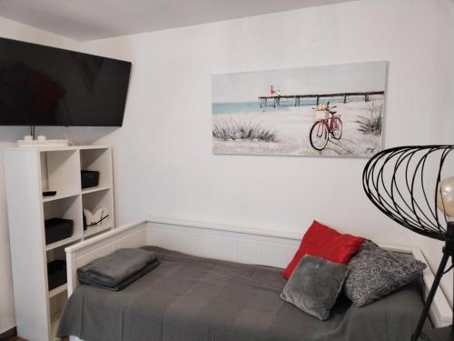 a bedroom with a bed and a picture of a beach at SUNSHINE Selce in Selce
