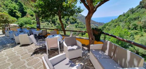 a group of chairs and tables on a balcony with a view at Agriturismo Costa di Campo in Vernazza