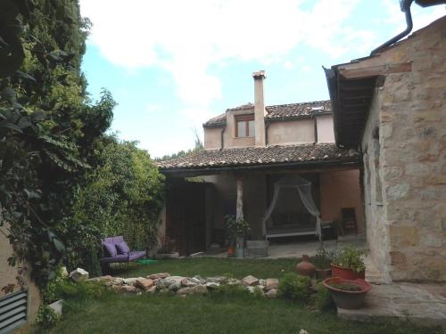 an outside view of a house with a yard at La Casona de Castilnovo - Gay Men Only in Valdesaz