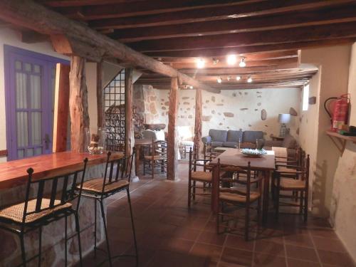 a dining room with tables and chairs in a building at La Casona de Castilnovo - Gay Men Only in Valdesaz
