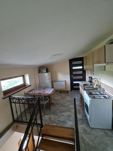 a kitchen with a white stove and a table at Приватна садиба "Лідія" in Truskavets