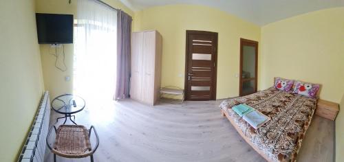 a living room with a couch and a room with a window at Приватна садиба "Лідія" in Truskavets