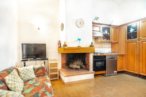 a living room with a couch and a fireplace at Villetta degli Oleandri - Geremeas 2 in Geremeas