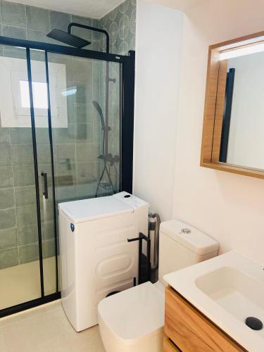 a bathroom with a shower and a toilet and a sink at Eco del Mar in Cala d´Or