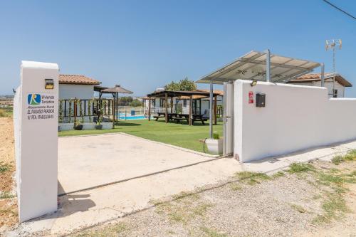 a white gas pump in a yard with a park at El Paraíso Perdido in Conil de la Frontera