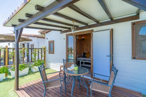 a patio with a table and chairs on a deck at El Paraíso Perdido in Conil de la Frontera