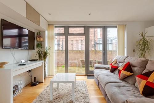 a living room with a couch and a table at Modern City Centre House with Free Parking in Canterbury